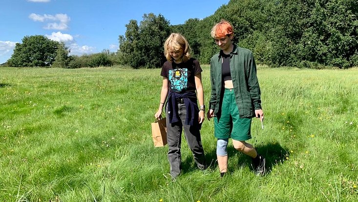 Zwei Teilnehmerinnen des FÖJ auf einer Wiese beim Saateneinsammeln